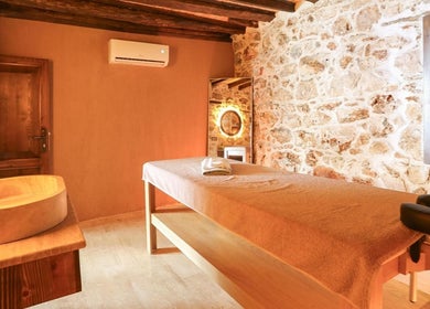 Tranquil massage room at Payam Spa & Wellness, Antalya, Antalya, TR with rustic stone walls and warm lighting.