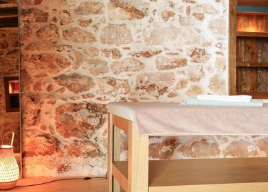 Rustic massage room at Payam Spa & Wellness, Antalya, Antalya, TR, featuring stone walls and warm lighting.