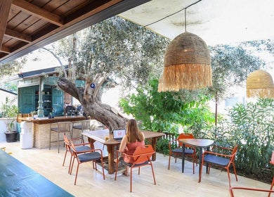 Relaxing outdoor seating at Payam Spa & Wellness, Antalya, TR, offering a serene, nature-inspired ambiance.