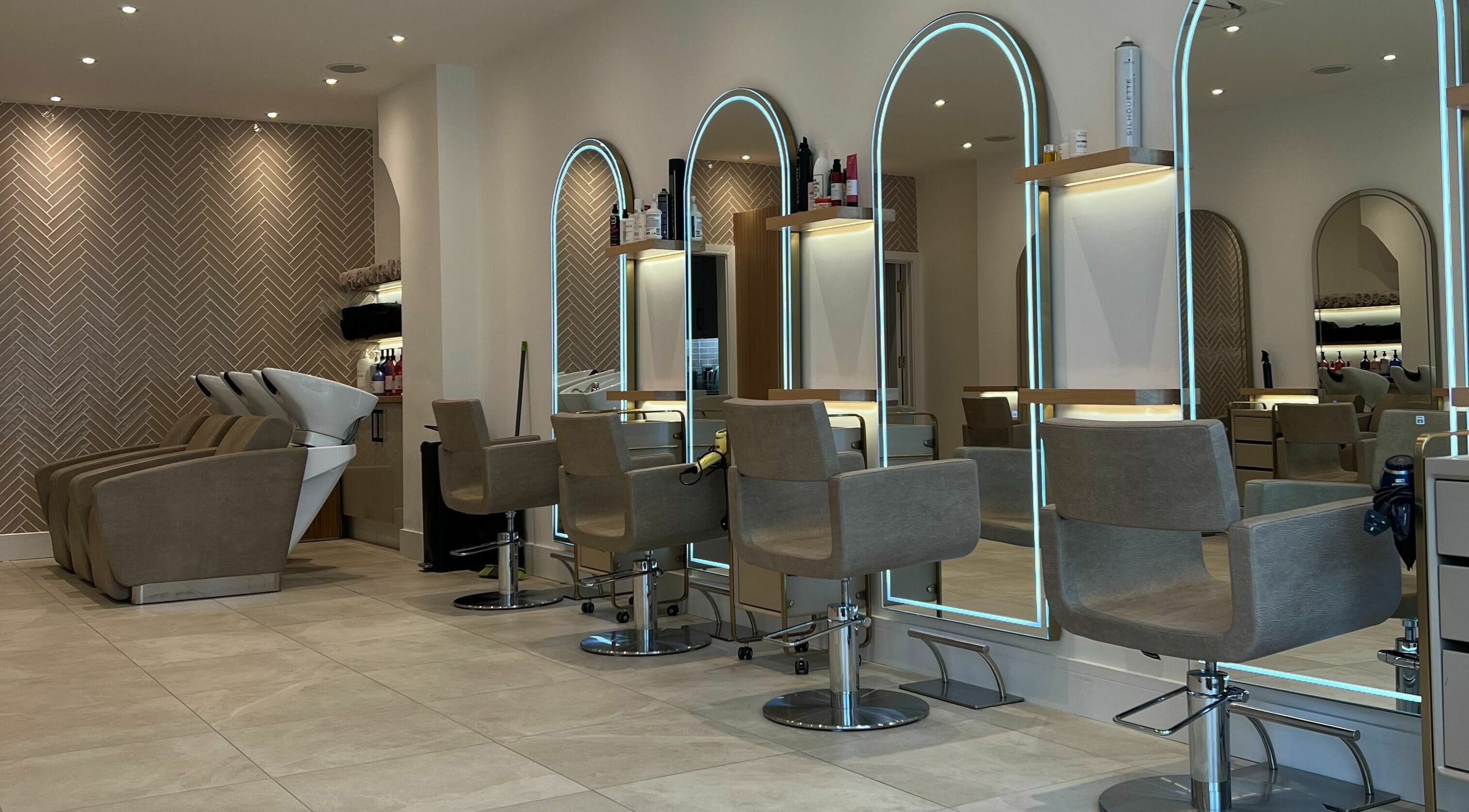 Modern interior of Elysia Valentina Hair Studio featuring stylish salon chairs in London, England, GB.