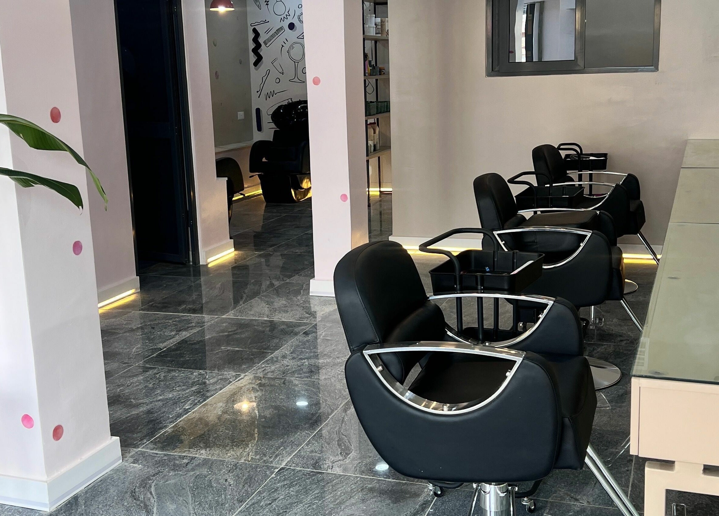 Stylish interior of Fluff n Puff salon with black chairs in Lekki, Lagos, NG.