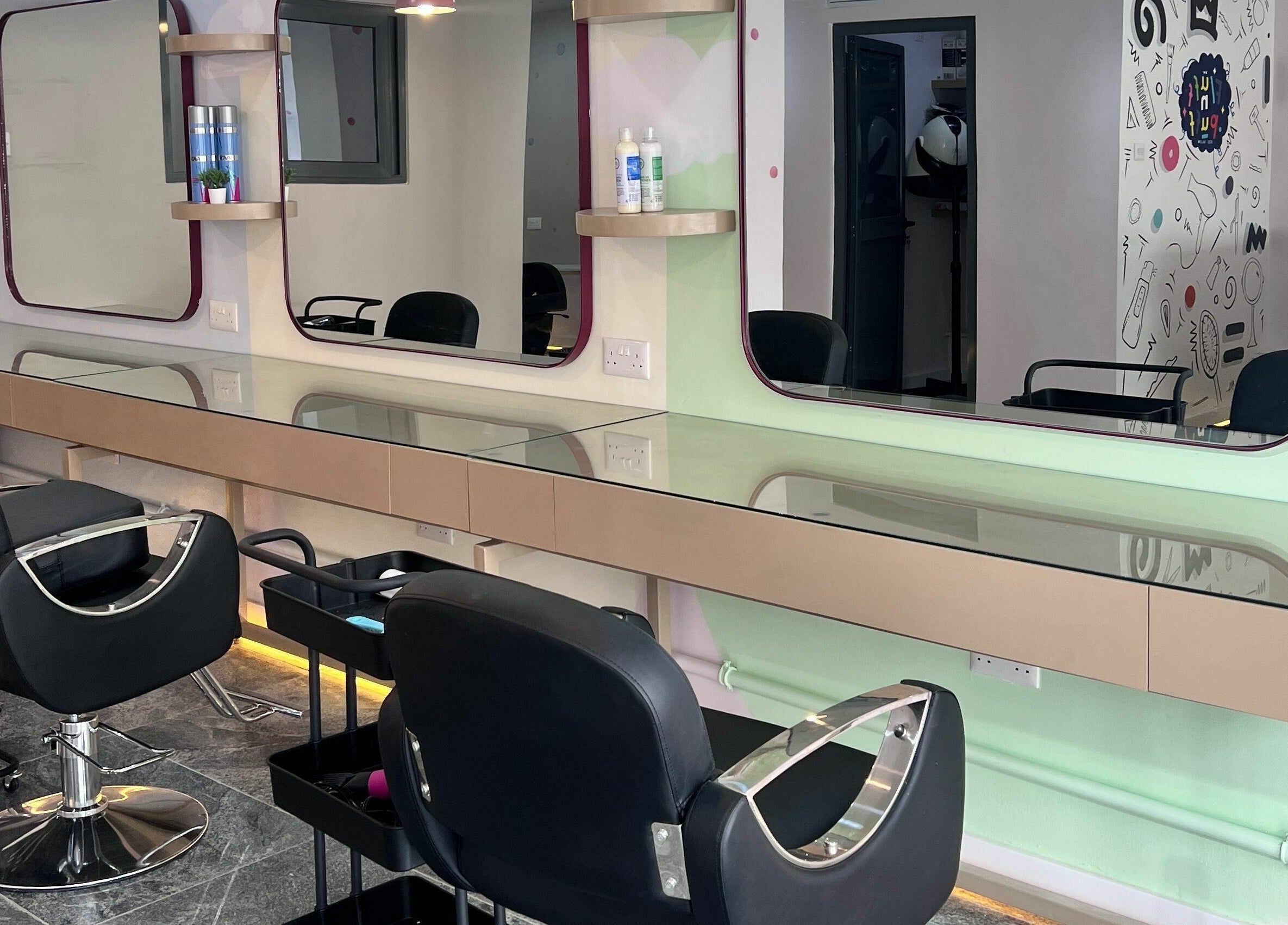 Modern styling chairs at Fluff n Puff salon, Lekki, Lagos, NG, with sleek glass-topped stations.