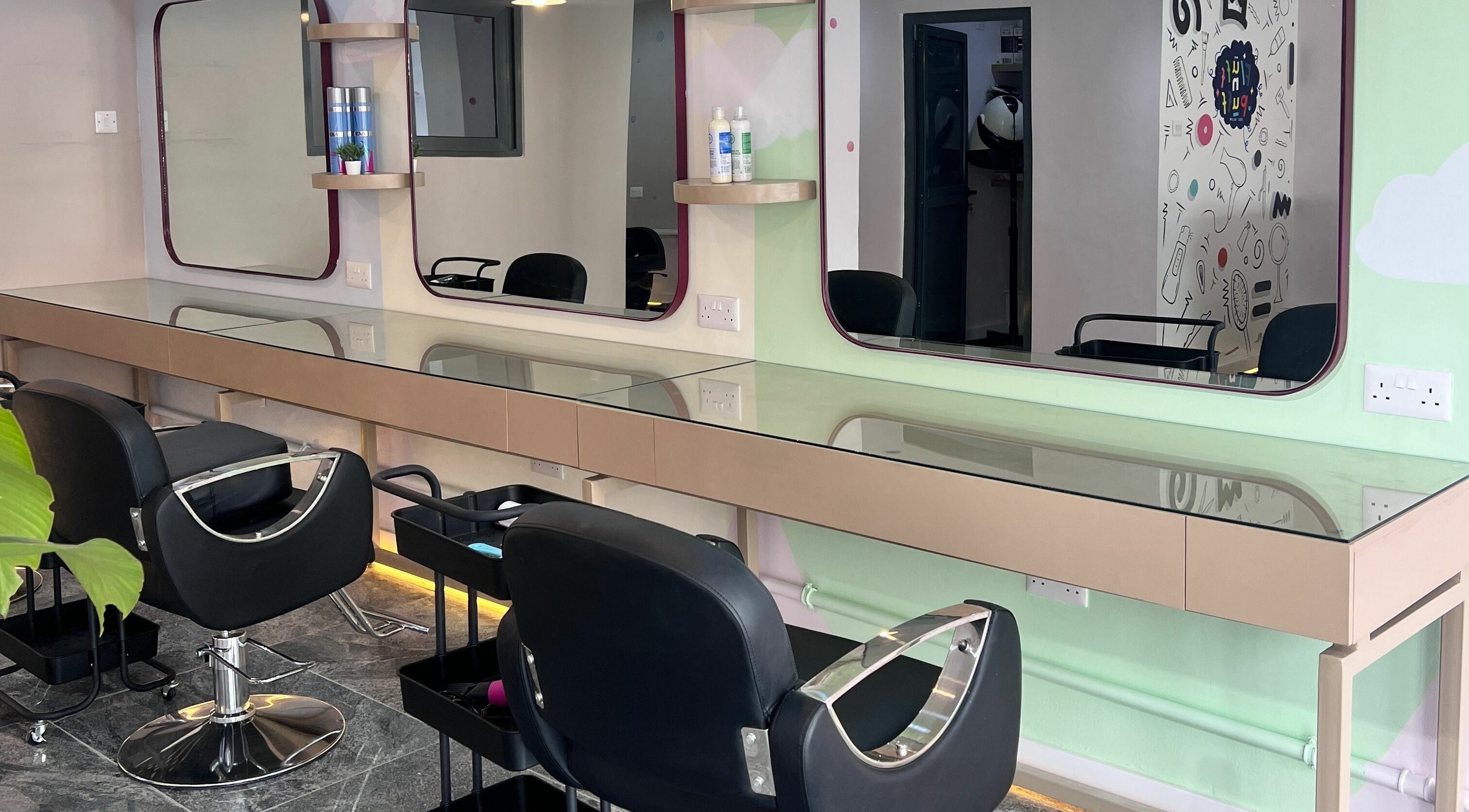 Modern styling chairs at Fluff n Puff salon, Lekki, Lagos, NG, with sleek glass-topped stations.
