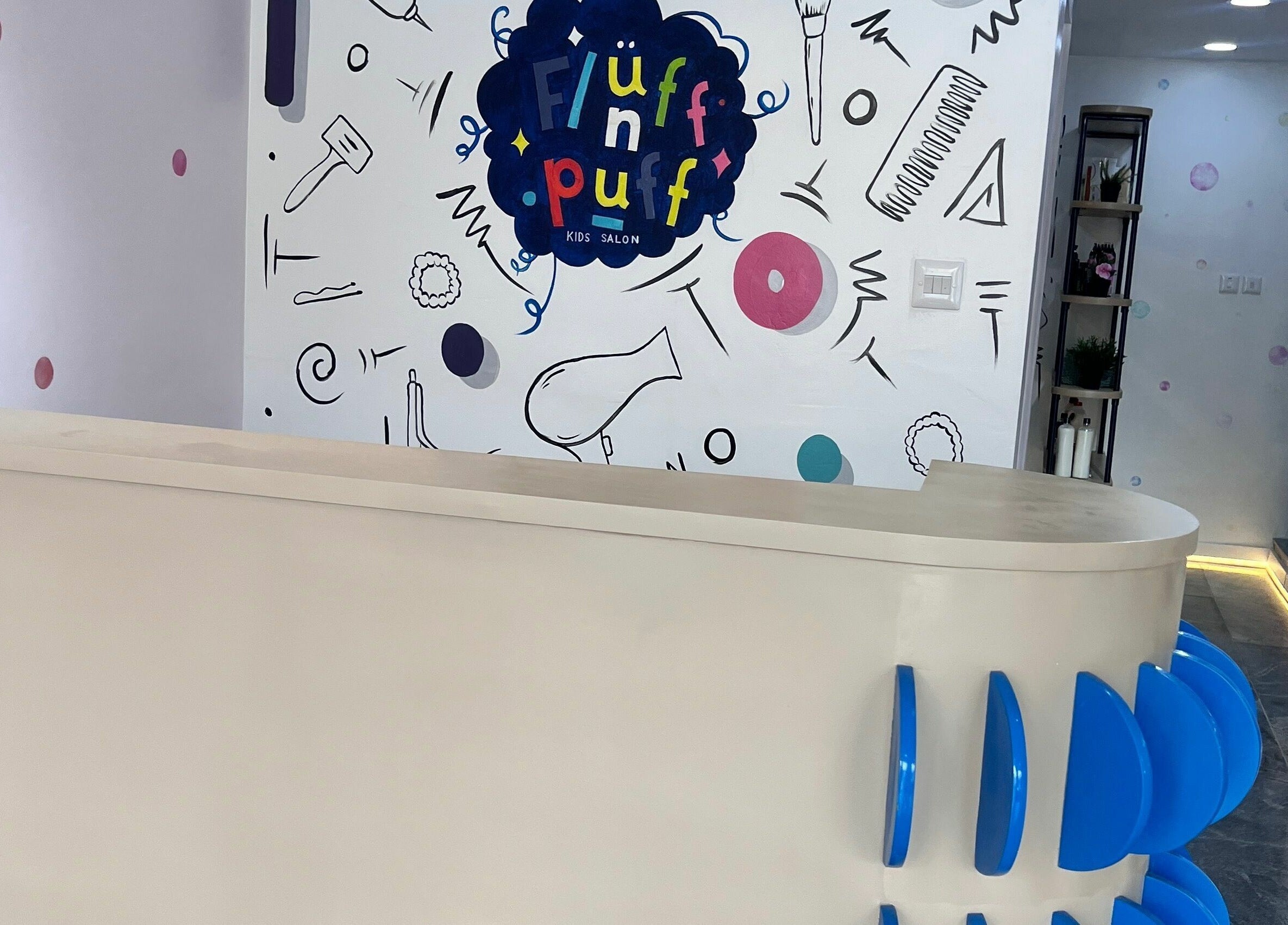 Reception desk at Fluff n Puff, Lekki, Lagos, NG, featuring vibrant decor and sleek design.