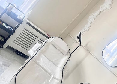 H Derma Beauti Aesthetics Norwich treatment room with a white chair and elegant decor in Norwich, England, GB.