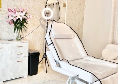 Elegant treatment room at H Derma Beauti Aesthetics Norwich, featuring a reclining chair and floral decor in Norwich, England, GB.