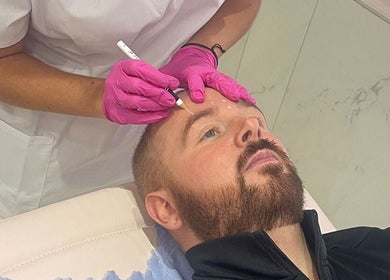Expert hand applies treatment at H Derma Beauti Aesthetics Norwich, England, GB for flawless skin results.