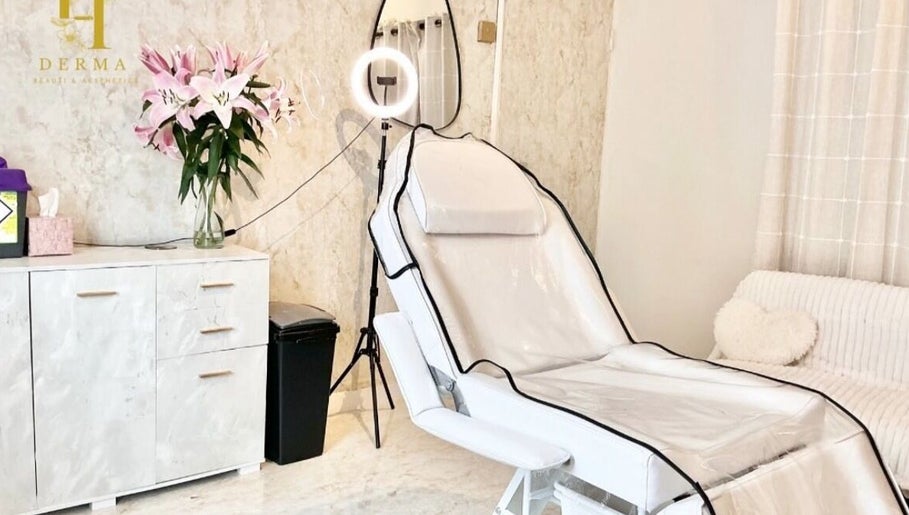 Tranquil treatment room at H Derma Beauti Aesthetics Norwich, featuring a plush chair and floral decor. Norwich, England, GB.