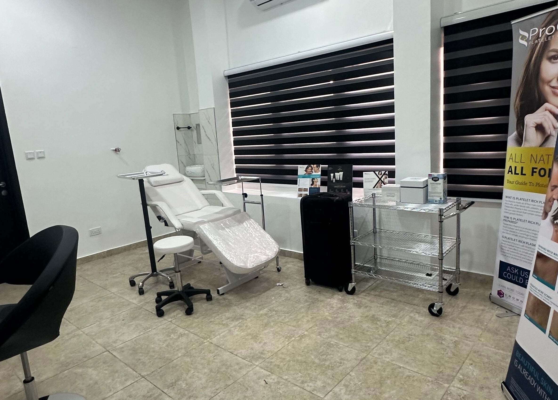 Serene treatment room at Care360 Aesthetics and Wellness, Lagos, NG, featuring modern equipment and stylish decor.