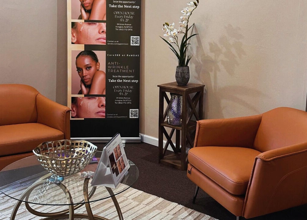 Elegant lounge area at Care360 Aesthetics and Wellness, Lagos, NG with plush chairs and a stylish decor display.