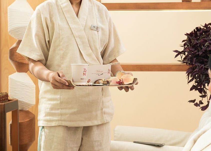 Attendant serving refreshments at Zen Spa I زن سبا, Riyadh, Riyadh Province, SA during a relaxing client session.