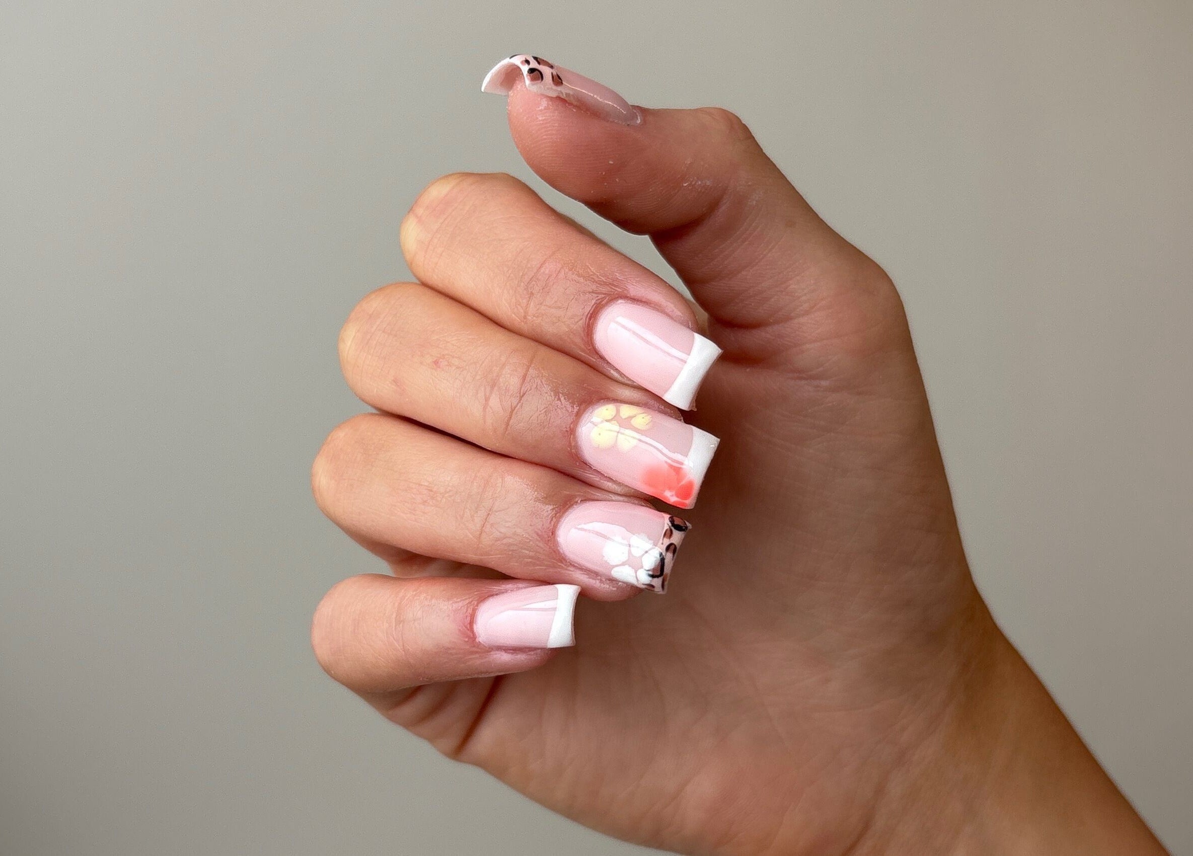 Detailed nail art manicure at Pura Vida Salon in Plymouth, England, GB. Featuring floral and geometric designs.