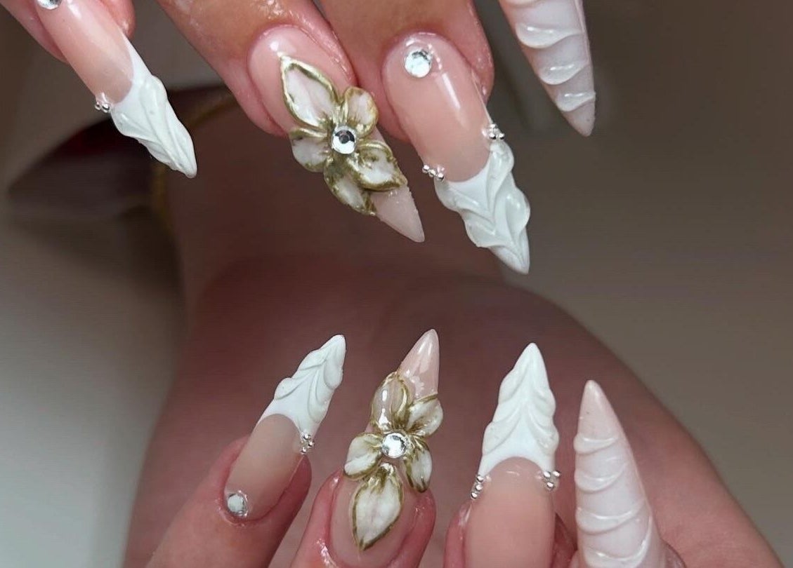 Intricate floral nail design at Pura Vida Salon, Plymouth, England, GB, showcasing artistic expertise.