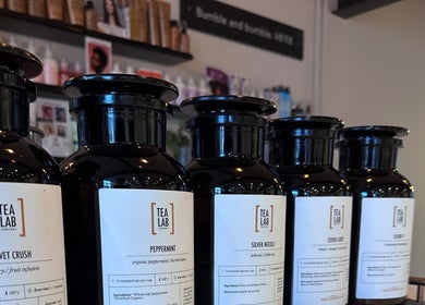 Close-up of tea jars displayed at Craft Hairdressing, Tring, England, GB, offering premium hair care products.