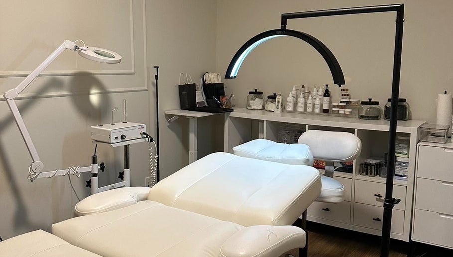 Salle de soins moderne à Enchanté Beautee, Laval, Québec, CA, avec table et équipements esthétiques.