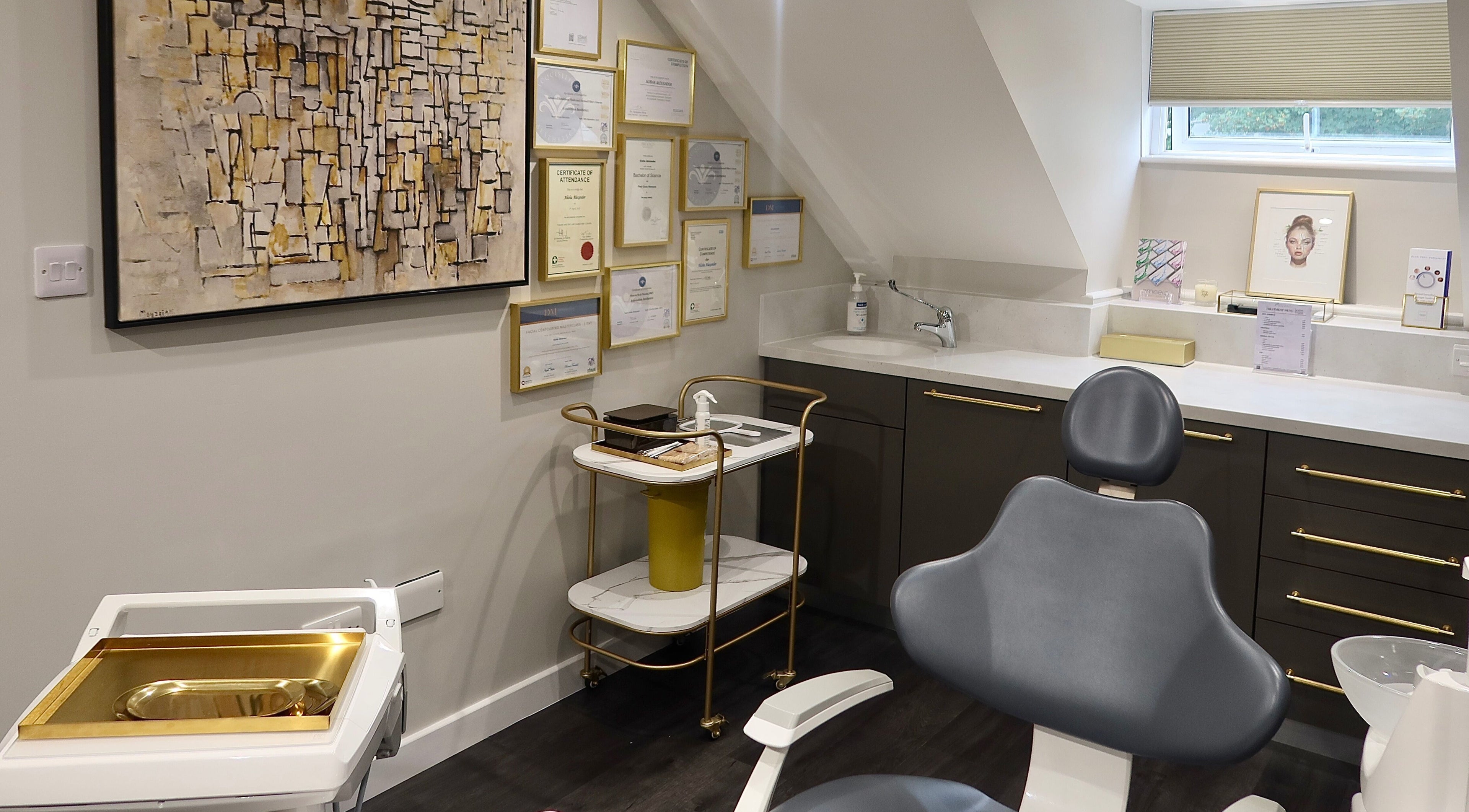 Modern treatment room at Alisha's Aesthetics in Guernsey, Saint Peter Port, GG with certificates on display.