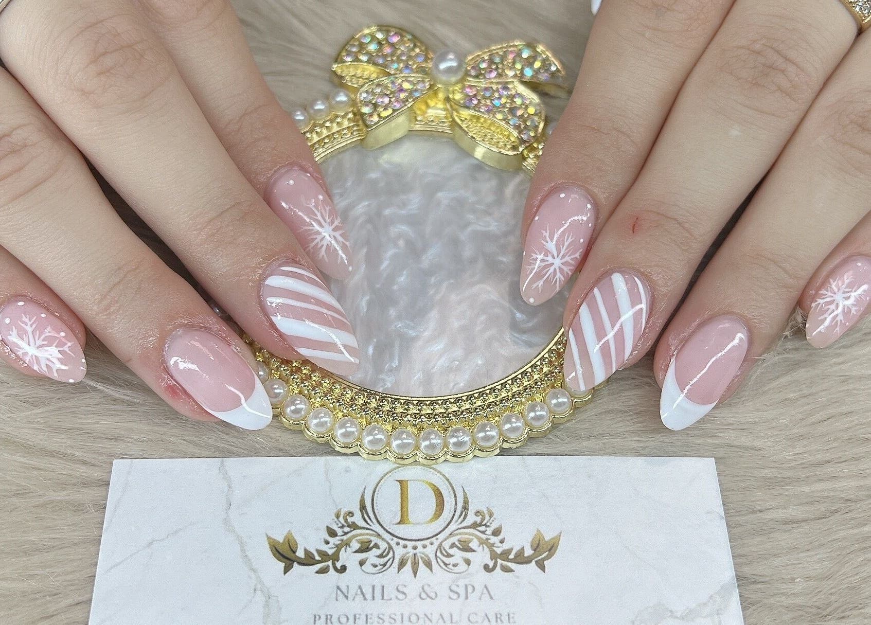 Snowflake-themed nail design at D Nails and Spa Dracut in Dracut, Massachusetts, US.