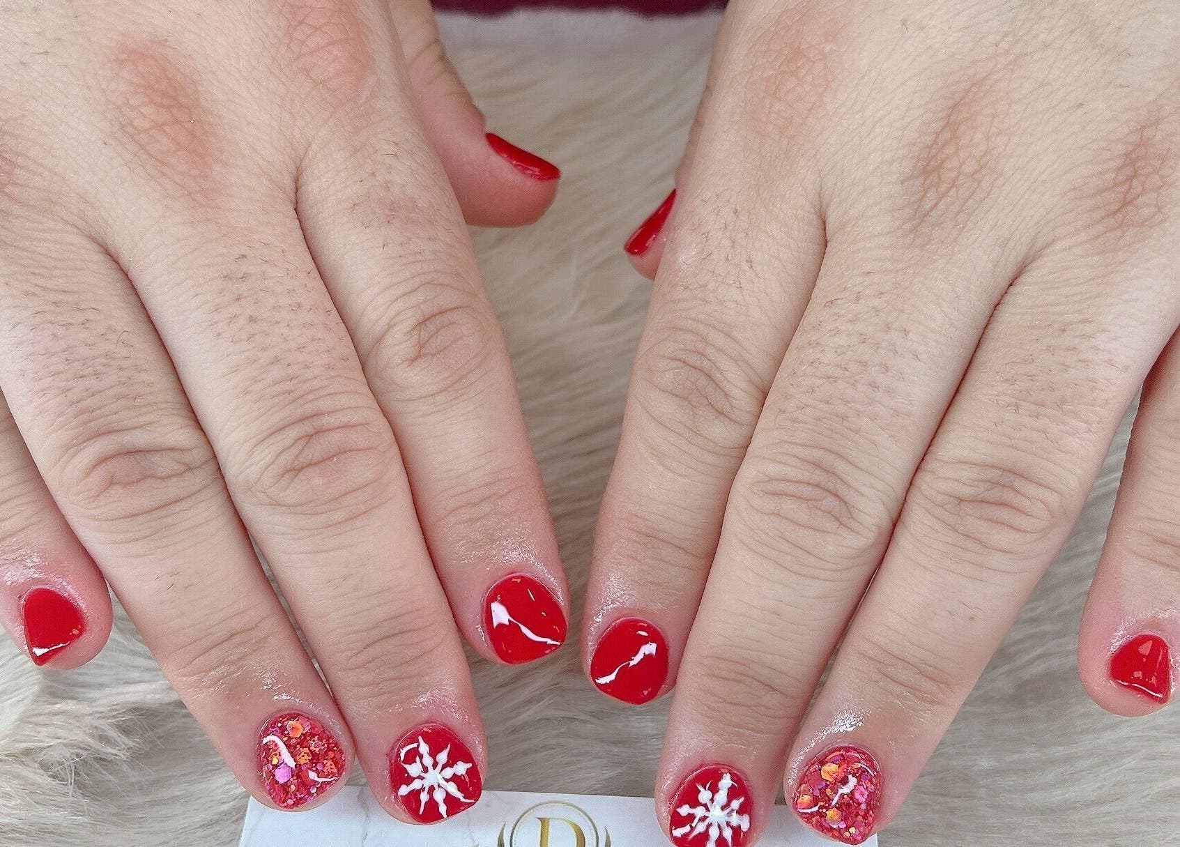 Festive red nail art at D Nails and Spa Dracut in Dracut, Massachusetts, US, showcasing unique designs.