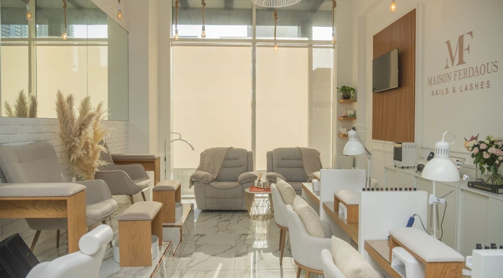 Elegant interior of Maison Ferdaous Nails & Lashes in Dubai, Dubai, AE featuring plush seating and stylish decor.