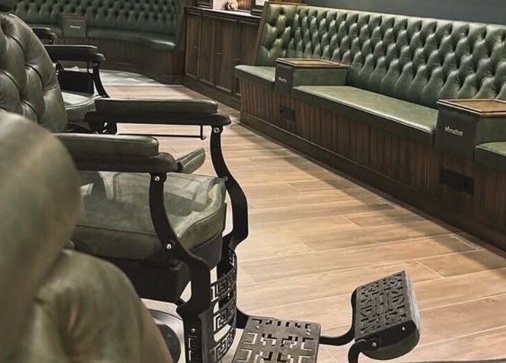 Luxurious interior of il-Mustaċċun Barber with classic green chairs in Ħal Lija, MT.