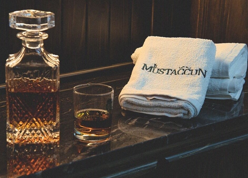 Crystal decanter with branded towels at il-Mustaċċun Barber, Ħal Lija, MT.