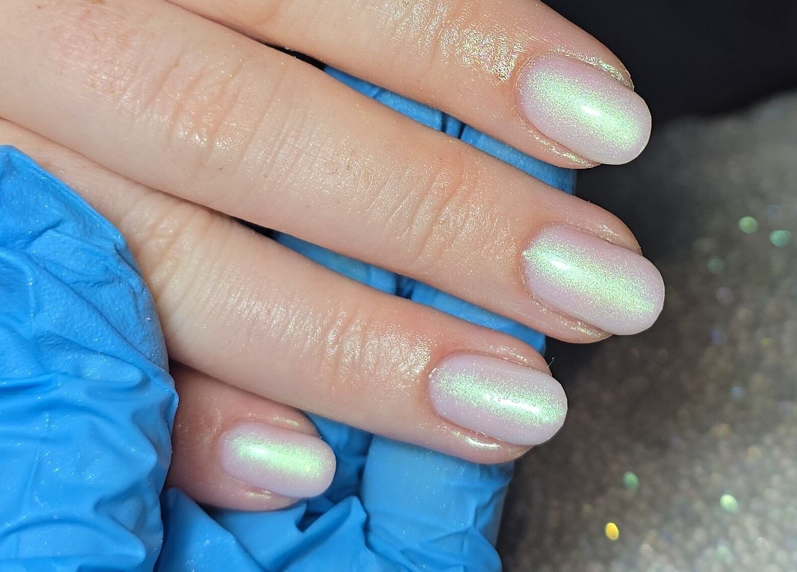 Iridescent nails at Nailed It By Laura, Carluke, Scotland, GB. Chic manicure in blue gloves.