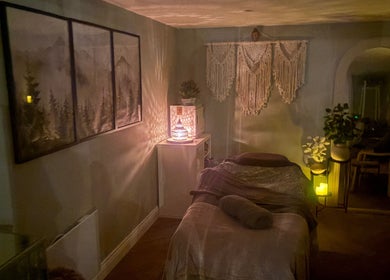 Cozy massage room at Susan Stevens Massage Therapist, Churchdown, England, GB, warmly lit and tastefully decorated.