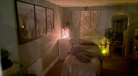 Tranquil massage room at Susan Stevens Massage Therapist in Churchdown, England, GB, softly lit with candles.