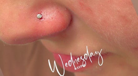 Nose piercing at Pierced, Tioga, North Dakota, US, showcasing elegant jewelry with a sparkling gem.