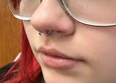 Close-up of a nose piercing at Pierced, Tioga, North Dakota, US showcasing stylish jewelry.