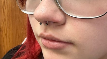 Close-up of a nose piercing at Pierced, Tioga, North Dakota, US showcasing stylish jewelry.