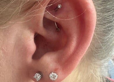 Close-up of ear piercings at Pierced, Tioga, North Dakota, US showcasing elegant diamond studs.