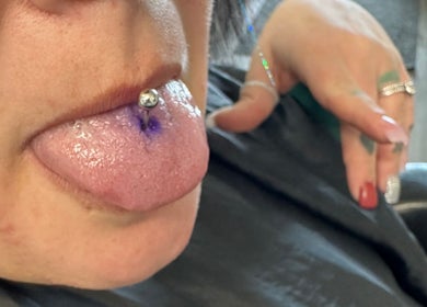 Tongue piercing with stud at Pierced, Tioga, North Dakota, US, showcasing professional body art.