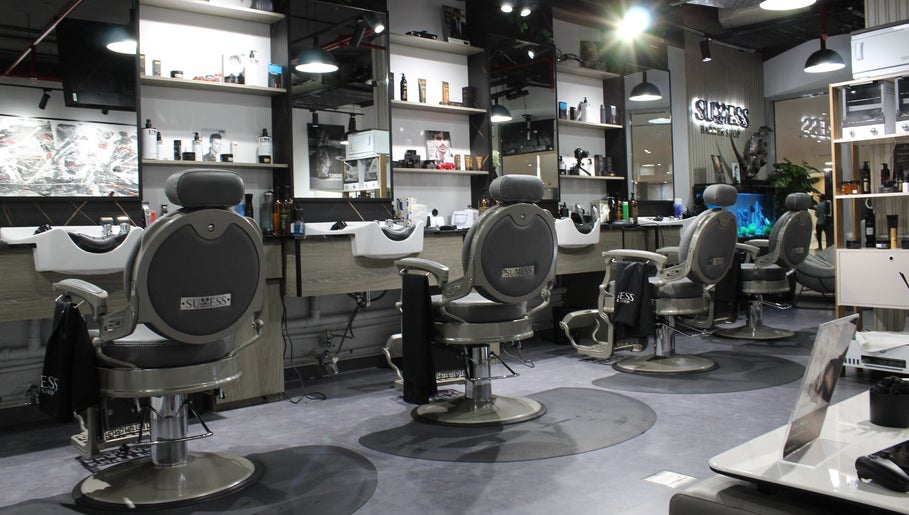 Modern interior of Success Barbershop, featuring sleek barber chairs in دبي, دبي, AE.