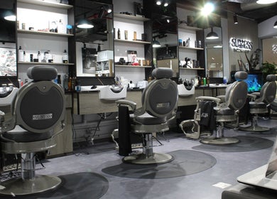 Modern interior of Success Barbershop, featuring sleek barber chairs in دبي, دبي, AE.