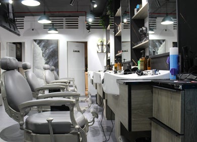 Modern interior of Success Barbershop in دبي, دبي, AE showcasing sleek chairs and stylish decor.