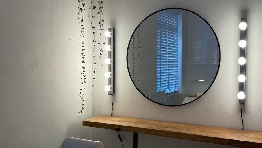 Chic vanity space at Fine Line By V, Long Eaton, England, GB, with round mirror and elegant lighting.