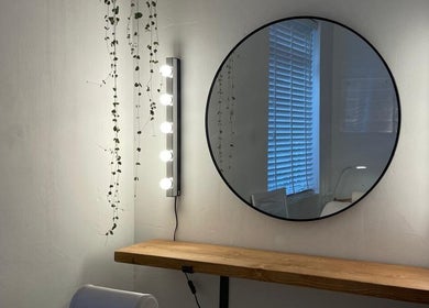 Chic vanity space at Fine Line By V, Long Eaton, England, GB, with round mirror and elegant lighting.