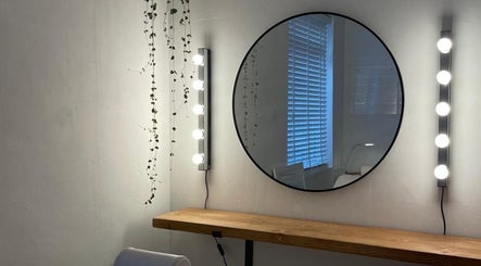 Chic vanity space at Fine Line By V, Long Eaton, England, GB, with round mirror and elegant lighting.