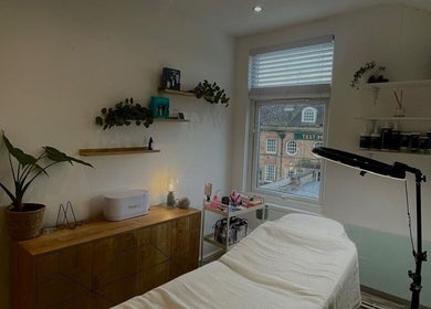 Relaxing treatment room at Fine Line By V, Long Eaton, England, GB with cozy decor and natural light.