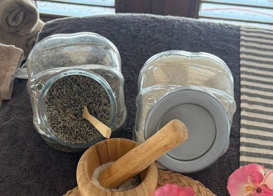 Aromatic lavender jars and wooden pestle at MG Organic Spa, Kralendijk, Bonaire, BQ, create a serene ambiance.