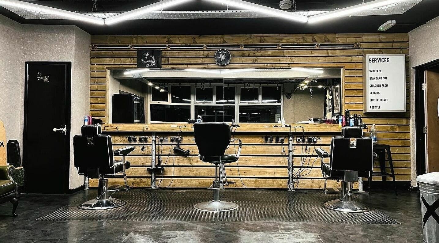 Interior of Conx barbers in Dinas Rhondda, Wales, GB with modern chairs and wooden decor.