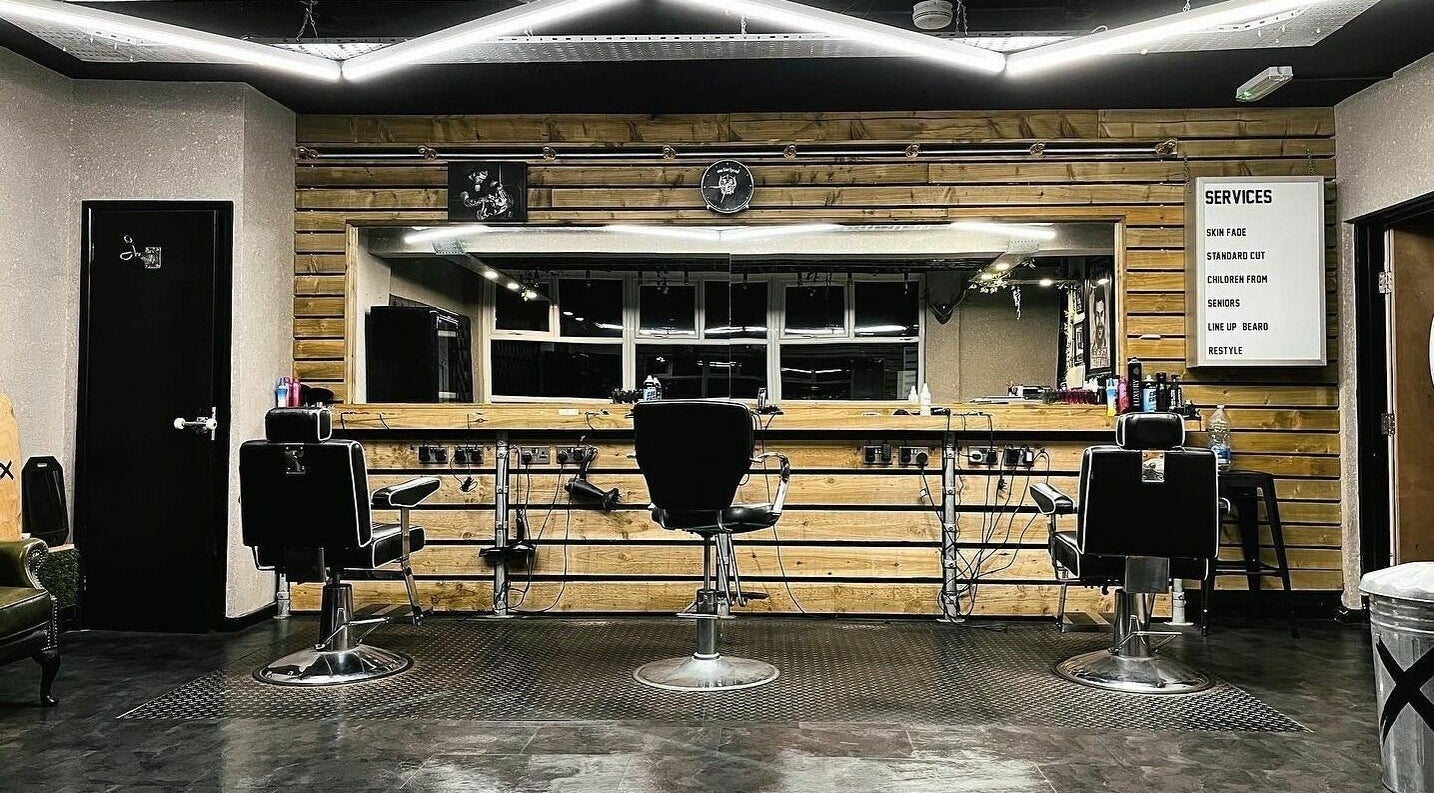 Interior of Conx barbers in Dinas Rhondda, Wales, GB with modern chairs and wooden decor.