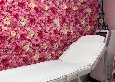 Treatment room with floral wall at My Beauty Lounge in London, England, GB, offering a serene spa experience.