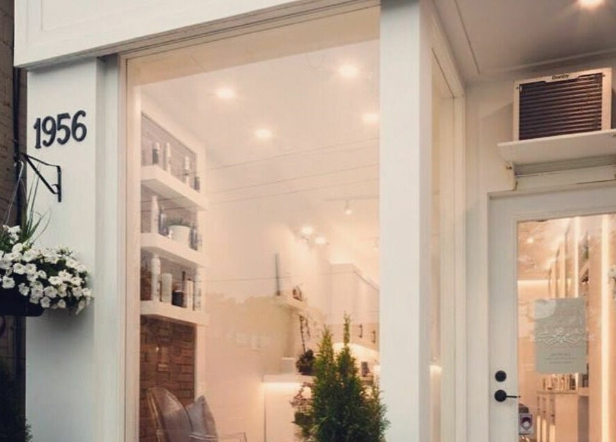 Front view of Marbella Hair Lab, a stylish salon in Toronto, Ontario, CA with elegant decor and greenery.