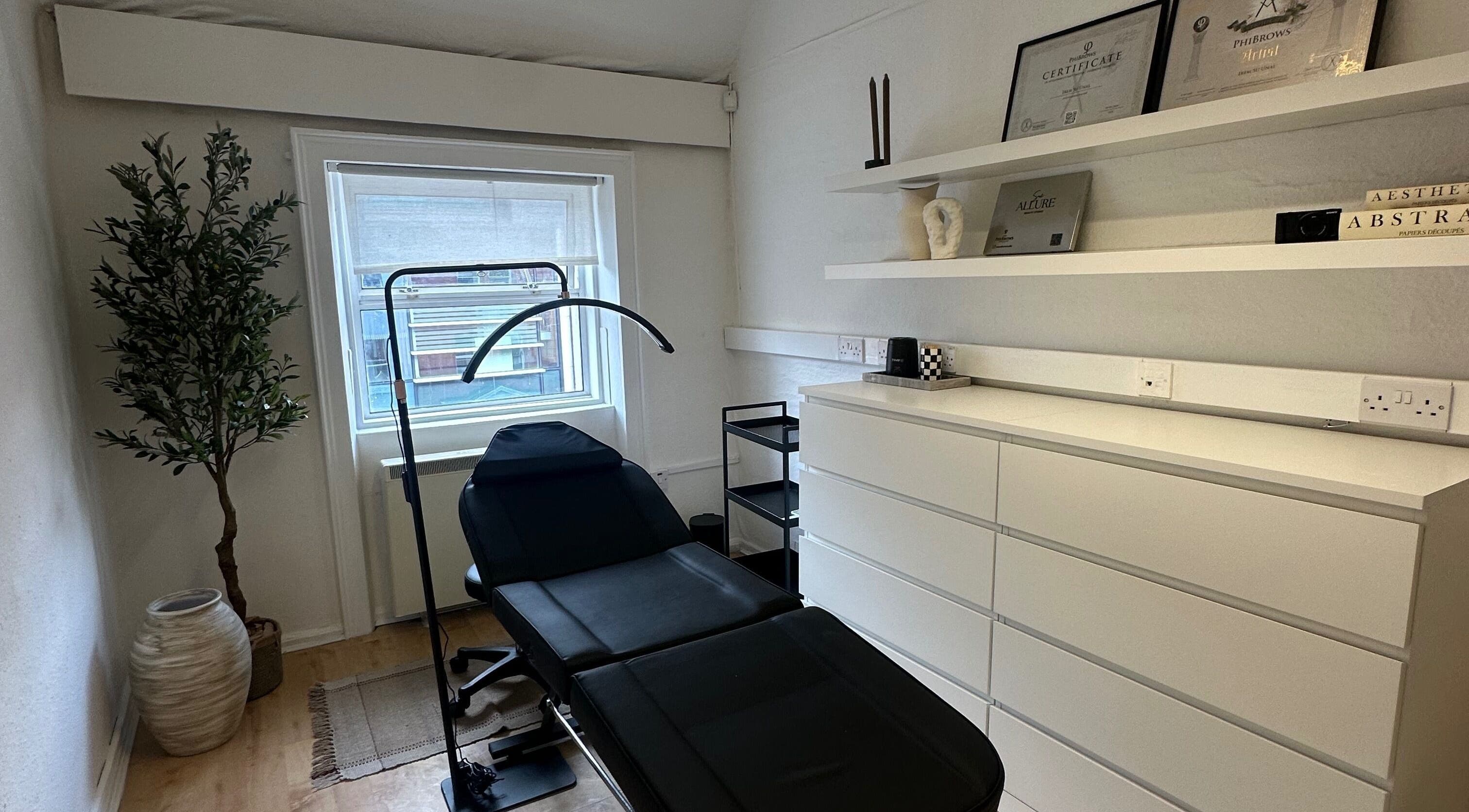 Elegant treatment room at Sue Allure Beauty Studio, Dublin, County Dublin, IE, featuring a modern black chair.