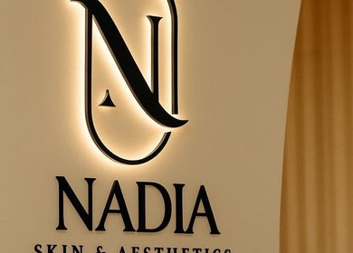 Elegant logo of Nadia Skin And Aesthetics, Stoke-on-Trent, England, GB, beautifully lit on a wall.