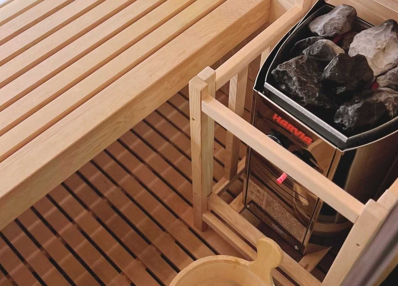 Wooden sauna at Oona Calming & Wellness Spa in Baliwag, Central Luzon, PH, featuring a stone heater.