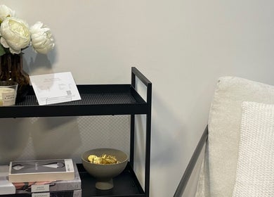 Cozy nook with decor at The Face Haven, Melbourne, Victoria, AU, featuring elegant flowers and books.