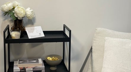 Cozy nook with decor at The Face Haven, Melbourne, Victoria, AU, featuring elegant flowers and books.